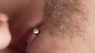 Digging in her twat, she loves feeling her pierced clit making her hot