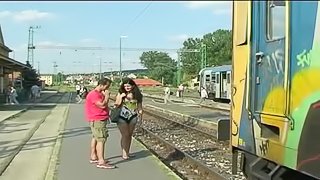 Judy Carmell is outdoors walking along the railroad tracks