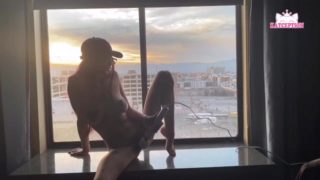 E girl with glasses masturbates and cums in front of Hotel window