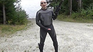 wetsuited silicone masked man on patrol near lake