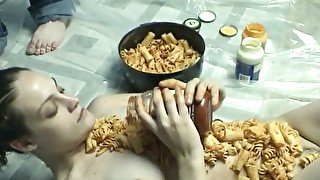 Kinky chick with food fetish covers her body with pasta and sauce