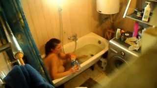 Voyeur spying on a bodacious brunette milf in the bathtub