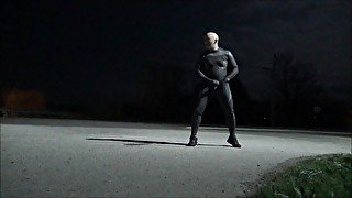 wetsuited guy jerking off in road and in front of house on full moon