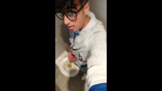 Twink with fat uncut cock piss at a rest stop toilet