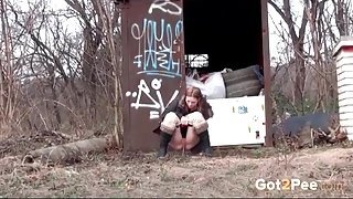 Cute girl walks the railroad tracks and pees