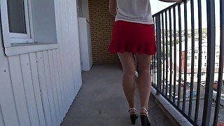 Slim girl with a beautiful booty takes off her panties on a public balcony Upskirt