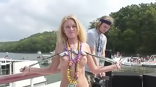 Blistering hot cowgirl in sexy bikini flashes her natural tits in wild yacht party