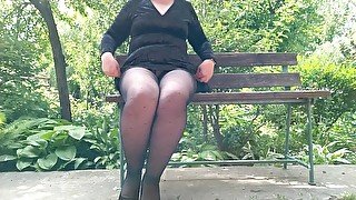 Naughty milf in pantyhose pissing in the park on a bench rear view