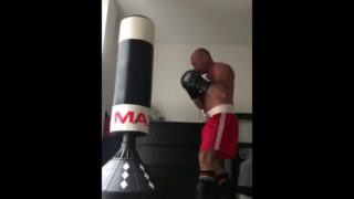 working the bag in red boxing trunks