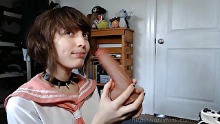 femboy schoolgirl gives a blowjob to his toy