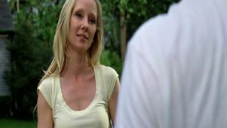 Anne Heche pulling herself up onto a dock beside a lake at