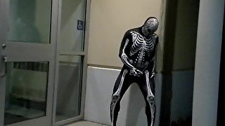 nighttime skeleton jerking off in front of outside doors