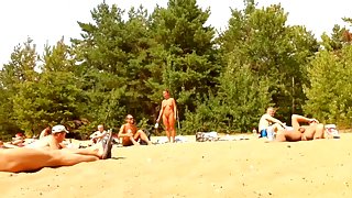 Wives and their husbands sunbathing at the nudist beach