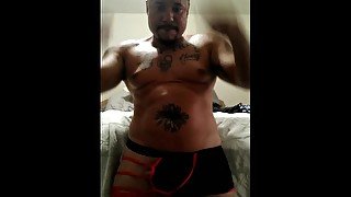 Sexy tattoo guy showing off in underwear