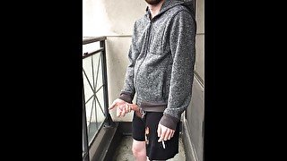 Skinny exhibitionist shows boner on public Toronto balcony while smoking