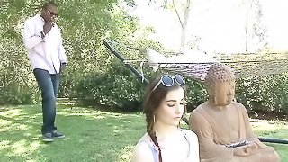 Lovely brunette meditates at the garden then her hairy pussy gets fucked by a black guy