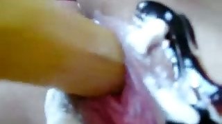 Mess loving nympho with jet black hair bangs her wet muff with a banana