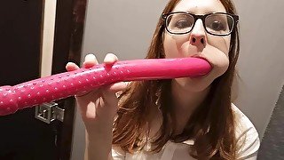 Lady with glasses plays with a dildo.