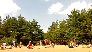 Naked people enloyong the sun on the beach