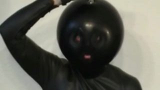 Latex Catsuit Girl With Black Rubber Ballhood Masturbates With Her Pussy