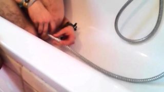 Bi-guy using shower head, squirting water, enema