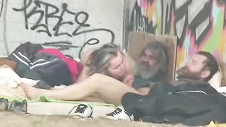 Two bums are screwing a mature slut under the bridge