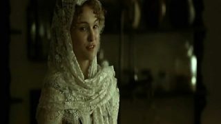Natalie Portman lying naked on her side on some hay on the