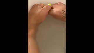 Wet ebony feet in bath tub