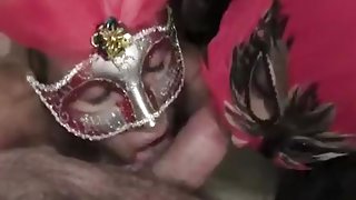 Two masked sluts shares and sucks hard erected dick