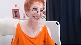 Skinny mommy in glasses stuffs her pussy with a dildo