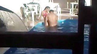 Voyeur tapes a latin couple having sex on the side of the pool