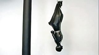 A bitch in latex overall gets suspended in BDSM scene