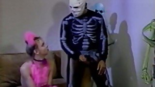 Cute white girl fucked by a helloween skeleton on the couch