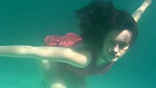 Luscious Russian brunette teen getting topless underwater