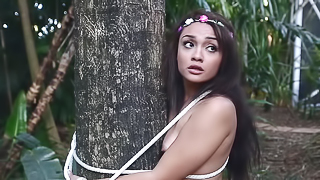 A nature girl is tied up and fucked in the forest by some trees