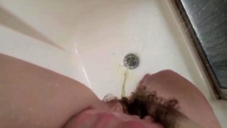Stacked brunette teen fingers her hairy cunt in the shower