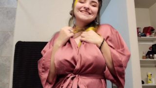 Goth girl gives playful strip tease dance in silk robe 