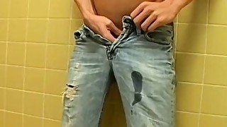 Hot young guy pisses his pants and jacks off his thick dick