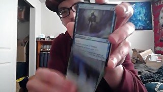 Cute Young Nerd Opening a Pack of Magic the Gathering Cards