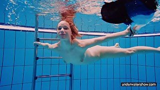 Teen girl Avenna is swimming in the pool