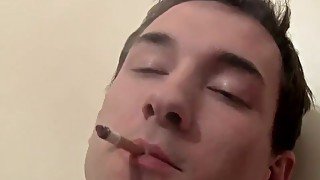 Tattooed twink chain-smoking while jerking off big cock solo