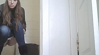 Slender white young lady in the public restroom pissing on hidden cam