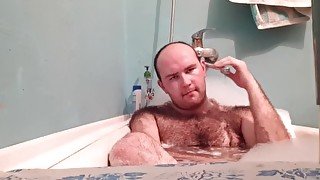 Hairy guy is satisfied in the bathroom.