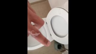 Hot and hung guy filming his dick while jerking off an cum into the toilet sink. 