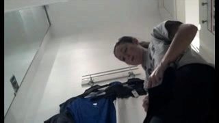 Hot Asian teen exposes her tight cunt in the dressing room