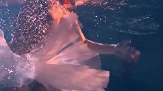 Bulava Lozhkova with a red tie and skirt underwater