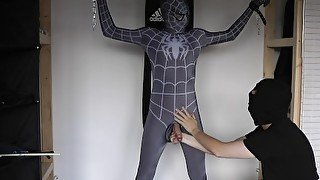 Ballbusting and electro on the balls of tied black Spiderman