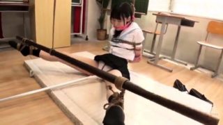 Cute Asian schoolgirl in uniform learns a lesson in bondage