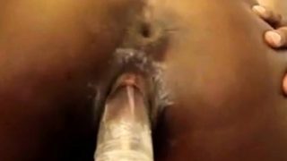 Ebony fucks her dildo close up from behind