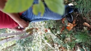 Guy taking a piss in the woods